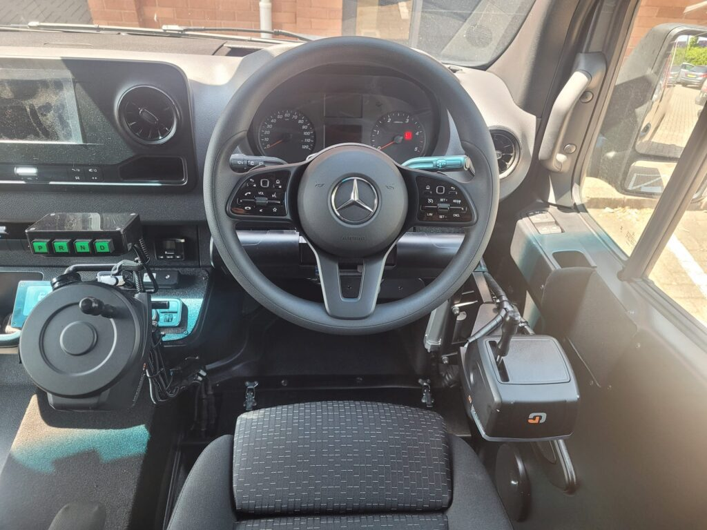 Mercedes Sprinter cockpit fitted with Joysteer electronic driving system, accelerator ring and gear selector