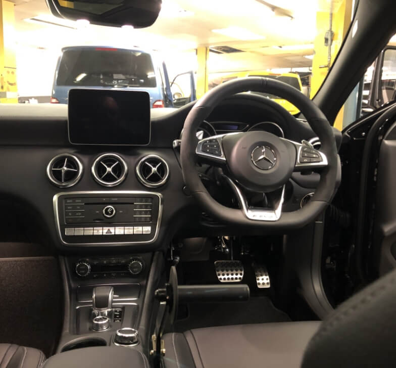 Close-up of the hand control linkage in the AMG A45 footwell