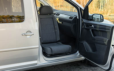 Car with passenger door open and the seat swivelled out for transfer