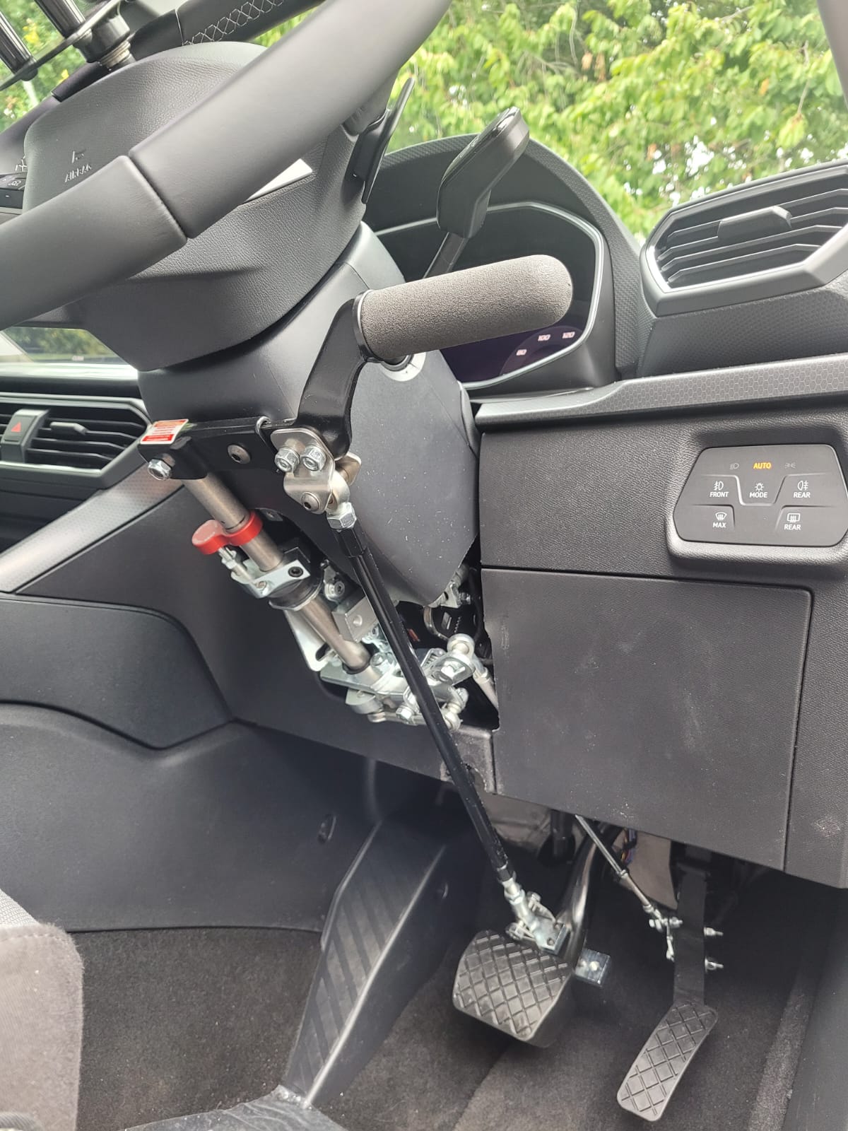 Radial hand control lever fitted beside the steering wheel and pedals