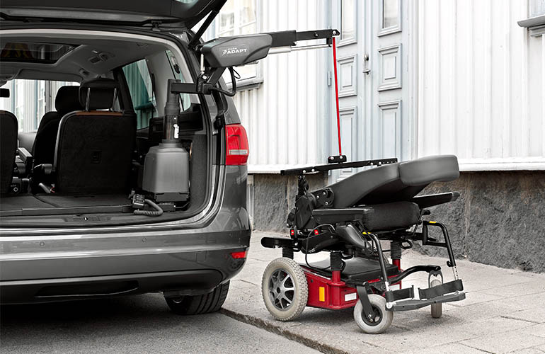 BraunAbility Carolift 6900 telescopic boot hoist lifting a wheelchair into a vehicle boot