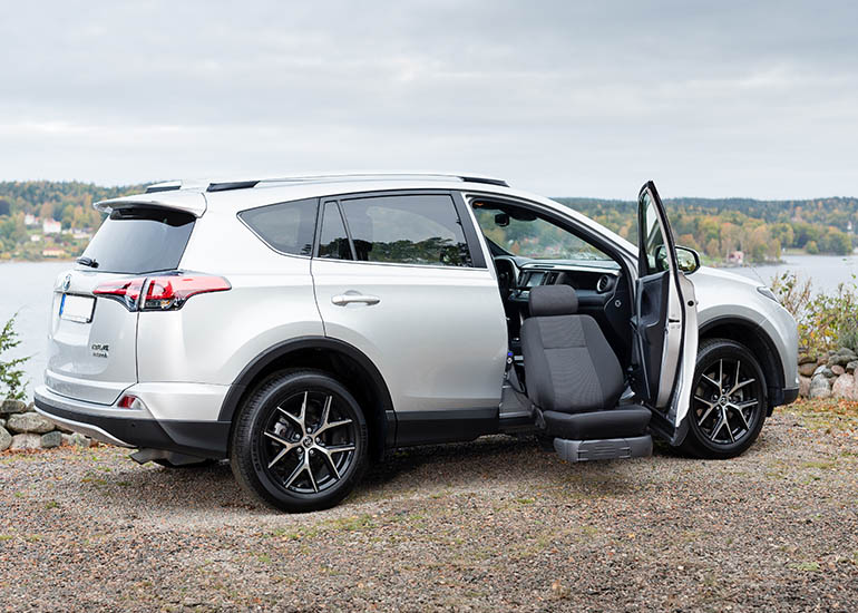 BraunAbility Turny Evo swivel seat lift rotated outward from a vehicle, ready for transfer
