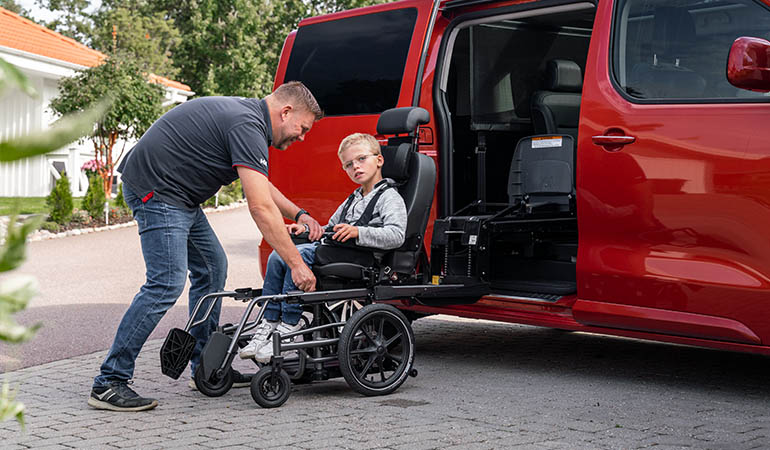 Carony seat sliding from its wheel base onto the swivel base fitted in a car