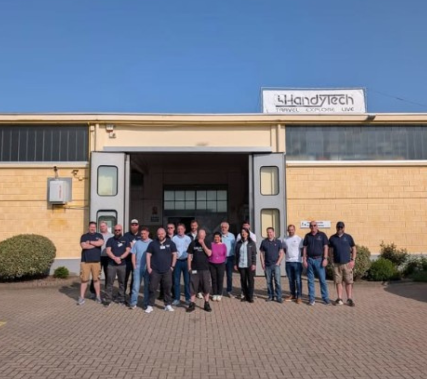 The Steering Developments and HandyTech teams outside the HandyTech workshop