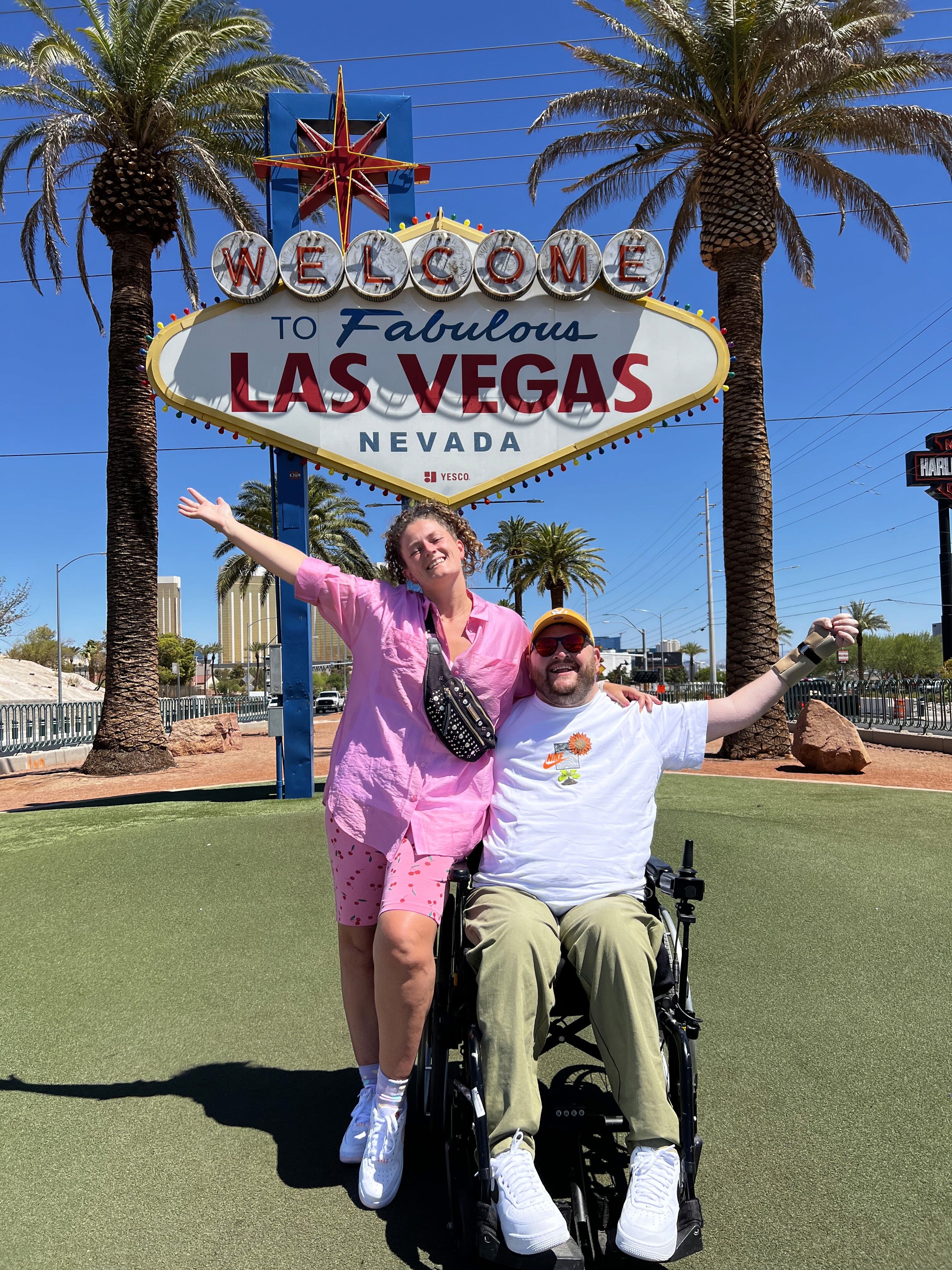 Gavin Wilson and his wife Alice beside the Welcome to Fabulous Las Vegas sign