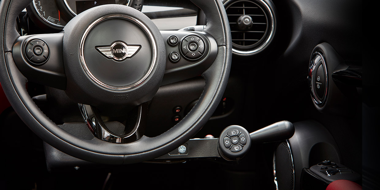 Mini steering wheel with an adapted joystick driving control ring fitted behind it