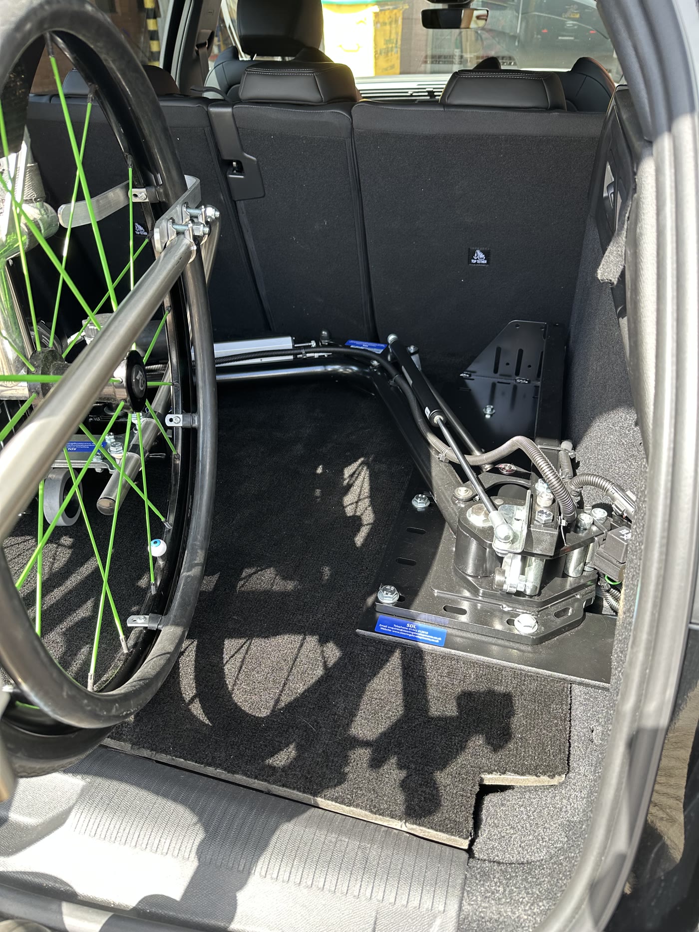 Abi Loader base plate and turntable in the boot with a manual wheelchair stowed beside it