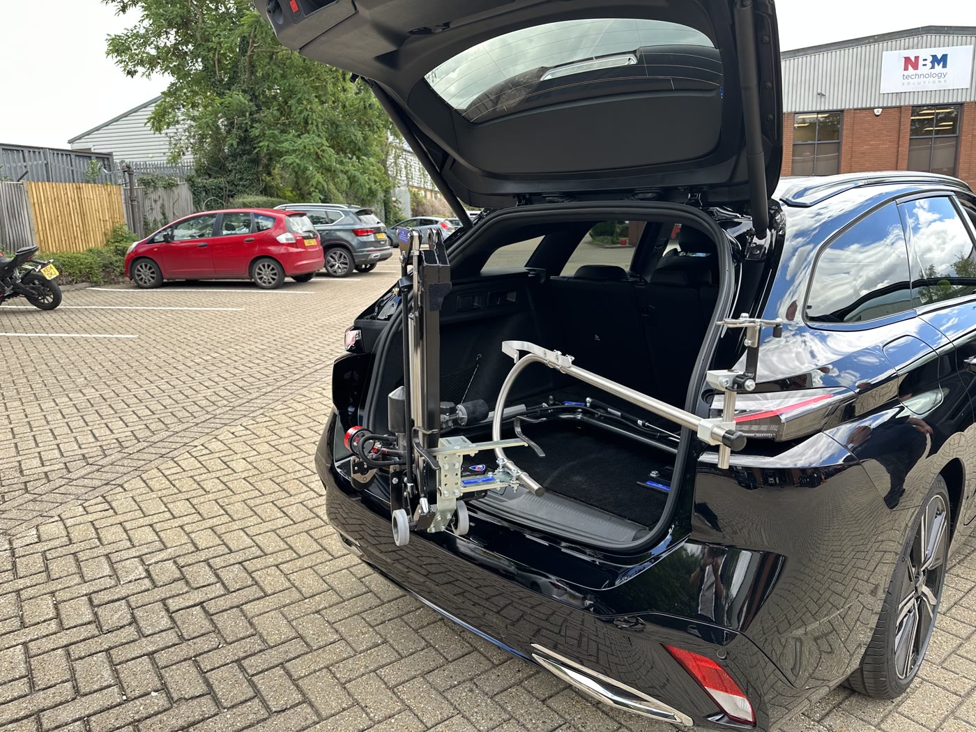 Abi-Loader wheelchair loading arm extended from a vehicle boot