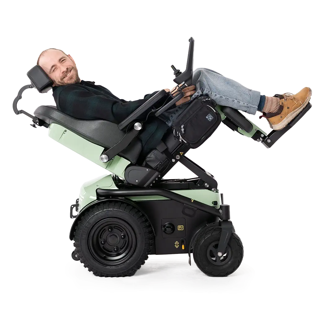 Man tilted back in a Freedom One Life Series 5 powerchair demonstrating the tilt function