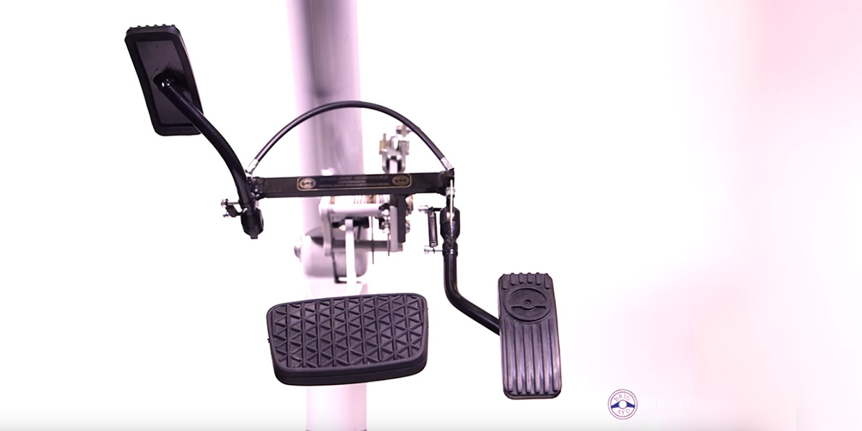 Twin flip up left foot accelerator pedal fitted beside the brake pedal in an automatic car