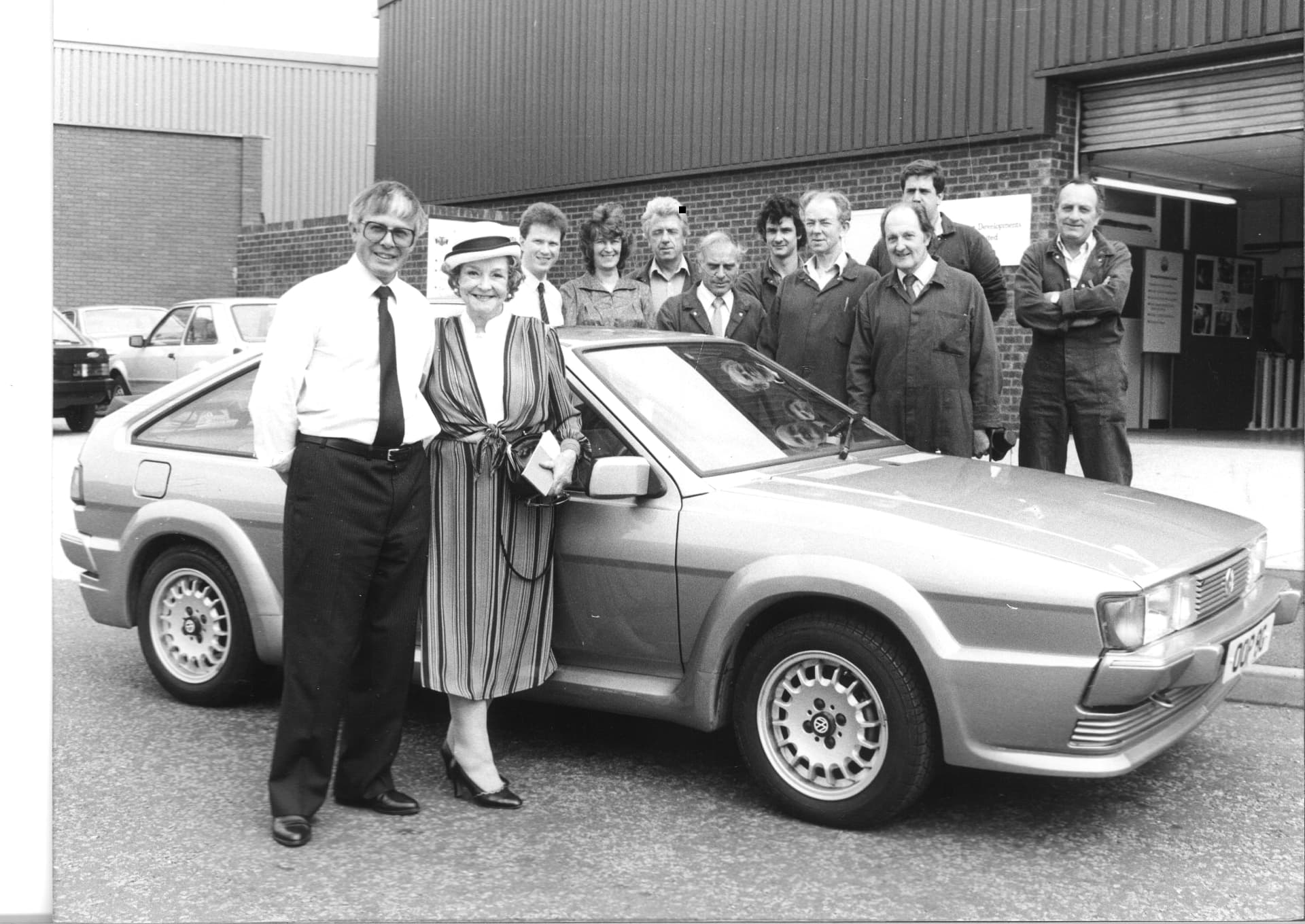 The team gathered outside the workshop with one of our adapted cars